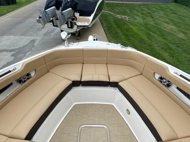 Slide: The Image of 2023 Sea Ray SLX 310 OB boat with tan seating and spacious bow area. - 14