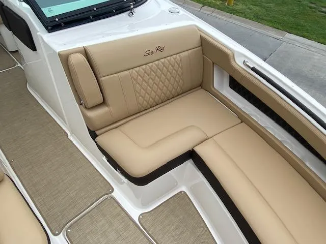 Slide: The Image of 2023 Sea Ray SLX 310 OB boat with tan leather seating and diamond stitching. - 17