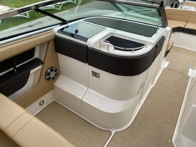 Slide: The Image of 2023 Sea Ray SLX 310 OB boat interior with beige seating and modern amenities. - 19
