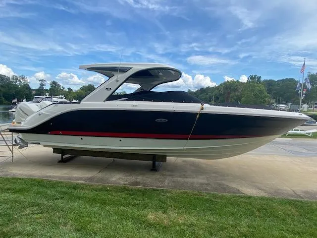 Slide: The Image of 2023 Sea Ray SLX 310 OB boat docked on a sunny day. - 2