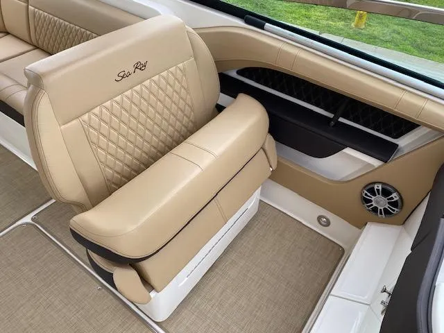 Slide: The Image of 2023 Sea Ray SLX 310 OB boat interior with tan leather seating and diamond stitching. - 21