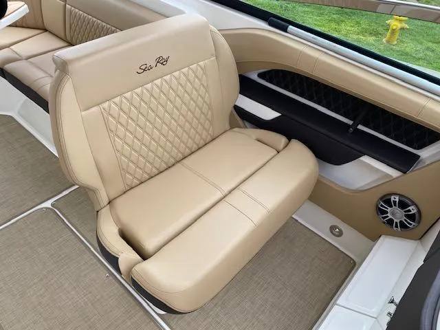 Slide: The Image of 2023 Sea Ray SLX 310 OB boat interior with beige leather seating. - 22