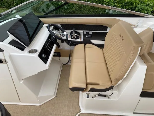 Slide: The Image of 2023 Sea Ray SLX 310 OB helm with tan leather seating and modern controls. - 25