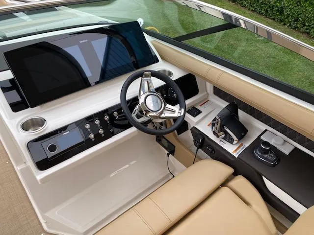 Slide: The Image of 2023 Sea Ray SLX 310 OB boat cockpit with modern steering and control panel. - 26