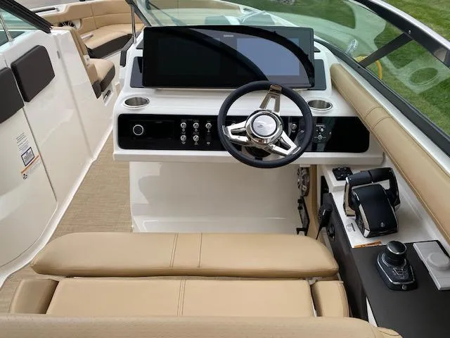 Slide: The Image of 2023 Sea Ray SLX 310 OB boat cockpit with modern steering wheel and control panel. - 27