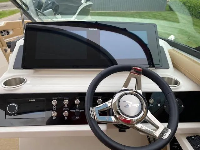 Slide: The Image of Steering console of 2023 Sea Ray SLX 310 OB with touchscreen display. - 28
