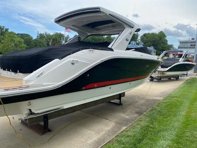 Slide: The Image of 2023 Sea Ray SLX 310 OB boat on display, black and white exterior. - 3