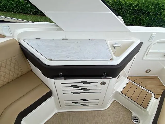 Slide: The Image of Interior of 2023 Sea Ray SLX 310 OB boat with seating and storage. - 33