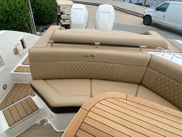 Slide: The Image of 2023 Sea Ray SLX 310 OB boat with tan leather seating and wooden deck. - 35