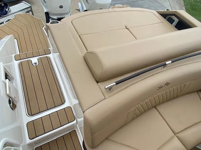 Slide: The Image of 2023 Sea Ray SLX 310 OB boat with tan leather seating and teak flooring. - 37