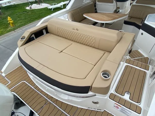 Slide: The Image of 2023 Sea Ray SLX 310 OB boat with tan seating and teak flooring. - 38