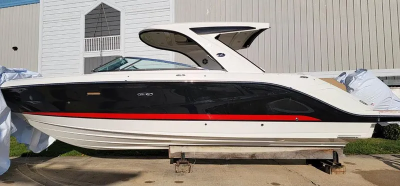 Slide: The Image of 2023 Sea Ray SLX 310 OB boat docked outside a building. - 4