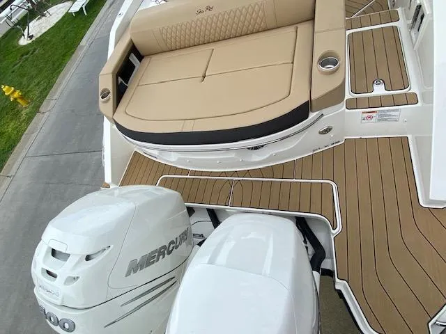 Slide: The Image of 2023 Sea Ray SLX 310 OB boat with twin Mercury outboard engines and tan seating. - 40