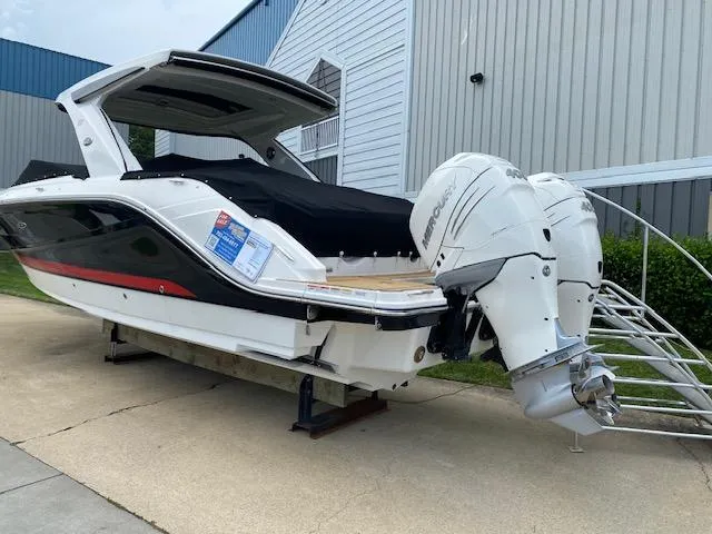 Slide: The Image of 2023 Sea Ray SLX 310 OB boat with twin outboard engines on display. - 5