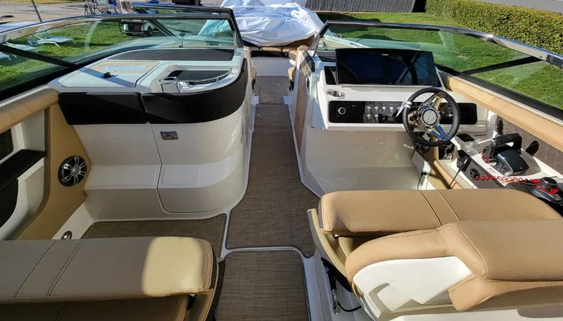 Slide: The Image of 2023 Sea Ray SLX 310 OB boat interior with dual helm seats and modern dashboard. - 7