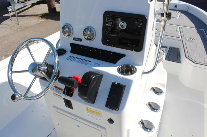 Slide: The Image of 2023 Avid 21 Mag boat console with steering wheel and controls. - 14
