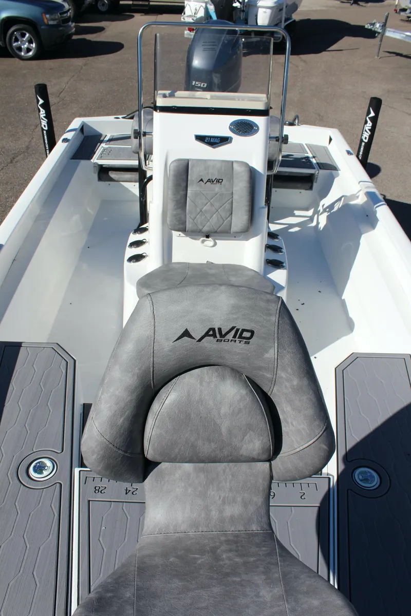 Slide: The Image of 2023 Avid 21 Mag boat interior with gray seating and console. - 15