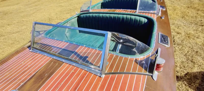 Slide: The Image of 1988 Hacker-Craft 30 Triple Cockpit boat with wooden deck and green interior. - 11