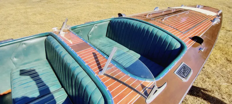 Slide: The Image of 1988 Hacker-Craft 30 Triple Cockpit boat with green leather seats and wooden deck. - 12