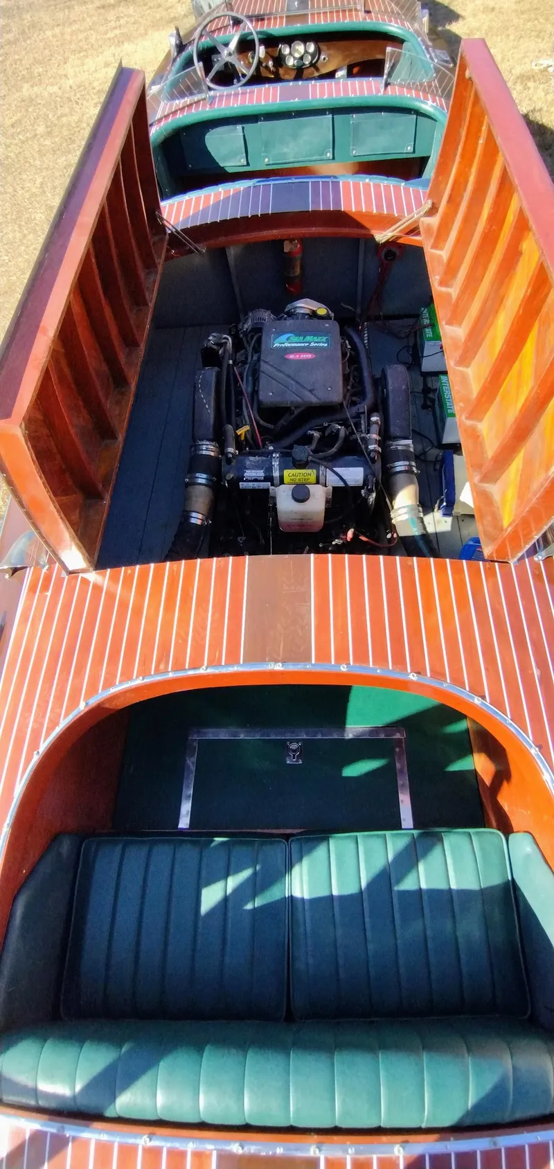 Slide: The Image of 1988 Hacker-Craft 30 Triple Cockpit boat with open engine compartment and green seating. - 14