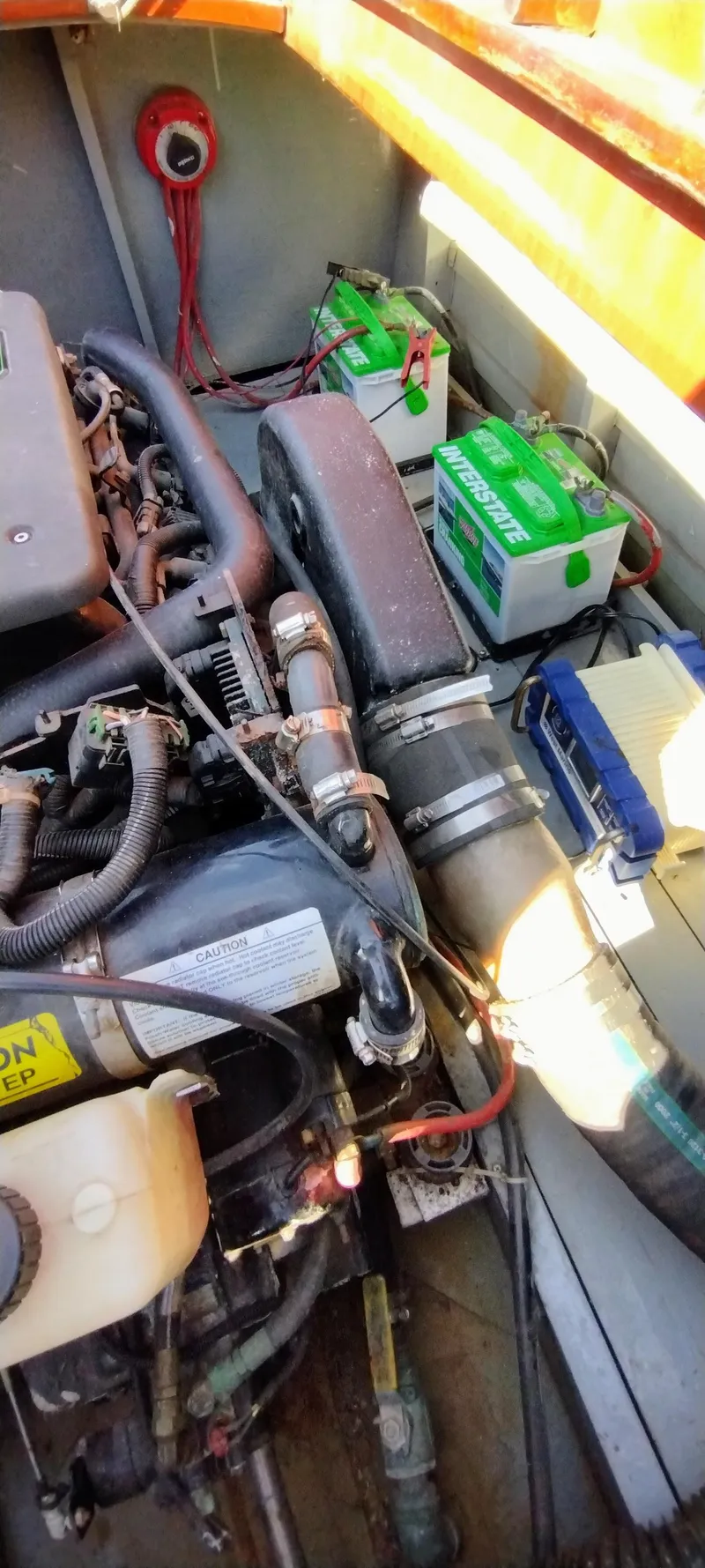 Slide: The Image of Engine compartment of a 1988 Hacker-Craft 30 Triple Cockpit with visible batteries and wiring. - 16