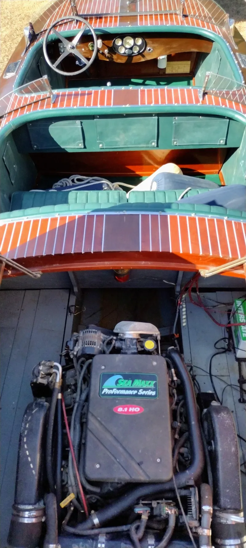 Slide: The Image of 1988 Hacker-Craft 30 Triple Cockpit boat with visible engine and wooden interior. - 18