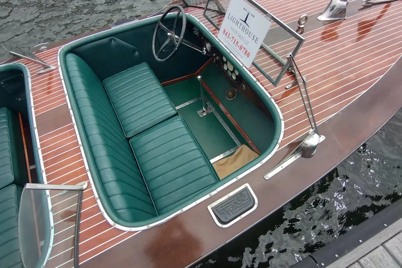Slide: The Image of 1988 Hacker-Craft 30 Triple Cockpit boat with green leather seats and wooden deck. - 20