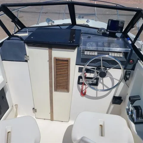 Slide: The Image of 1993 Bayliner Trophy boat cockpit with steering wheel and control panel. - 3