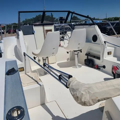 Slide: The Image of 1993 Bayliner Trophy boat interior with dual white captain chairs and steering wheel. - 7
