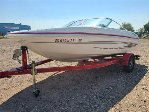 Slide: The Image of 2010 Glastron MX 185 boat on a red trailer in a gravel lot. - 7