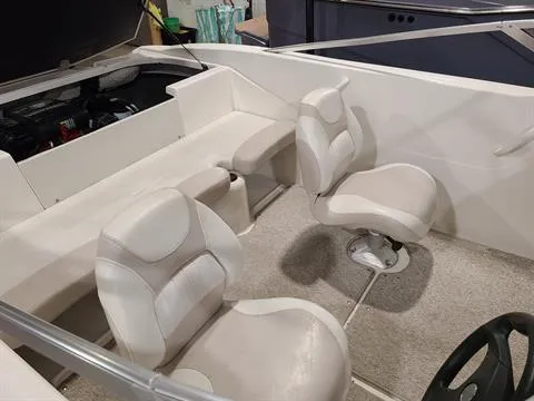Slide: The Image of 2007 Glastron MX 175 boat interior with white and beige seating. - 10