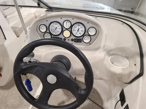 Slide: The Image of 2007 Glastron MX 175 boat dashboard with steering wheel and instrument gauges. - 2