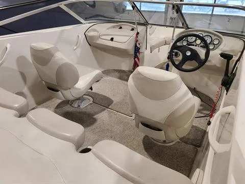 Slide: The Image of 2007 Glastron MX 175 boat interior with white seats and steering console. - 4