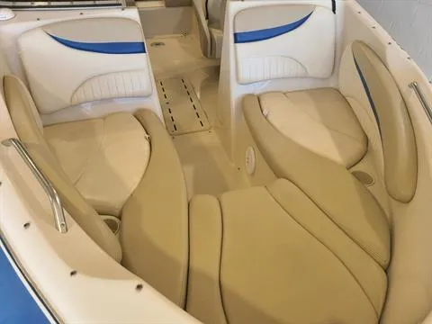 Slide: The Image of 2004 Glastron GX 235 boat interior with beige and blue seating. - 3