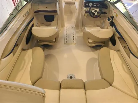 Slide: The Image of 2004 Glastron GX 235 boat interior with beige seating and steering console. - 6