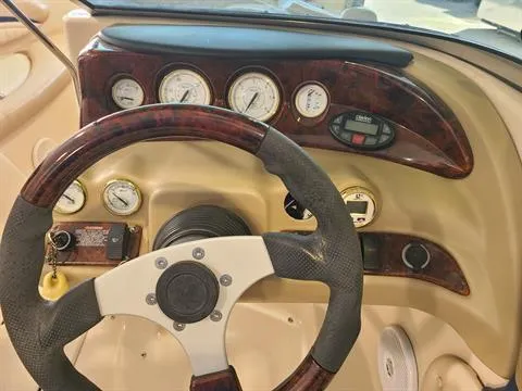 Slide: The Image of 2004 Glastron GX 235 boat dashboard with steering wheel and gauges. - 7