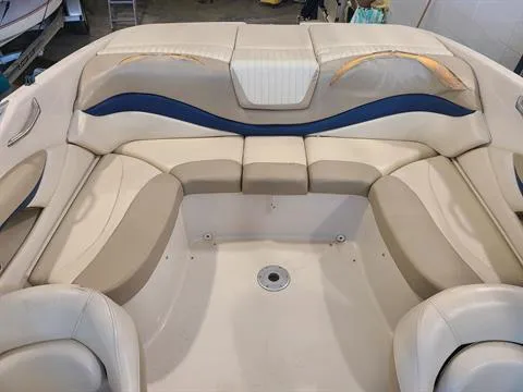 Slide: The Image of 2004 Glastron GX 235 boat interior with beige and blue seating. - 8