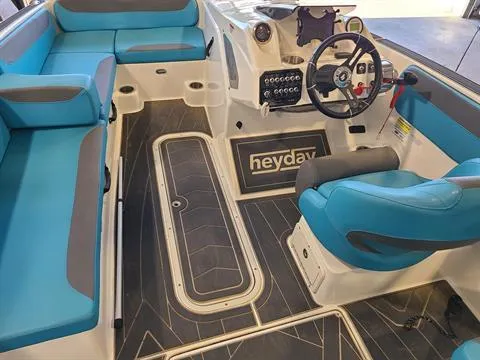 Slide: The Image of 2018 Heyday WT-2 boat interior with blue and gray seating, steering wheel, and control panel. - 5