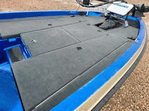 Slide: The Image of 2002 Javelin 200 DC boat deck with gray carpet and blue trim. - 2