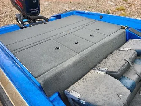 Slide: The Image of 2002 Javelin 200 DC boat with Evinrude motor, blue exterior, and gray interior storage compartments. - 3