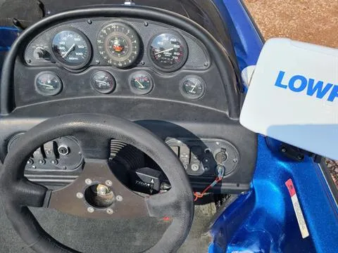 Slide: The Image of Dashboard of a 2002 Javelin 200 DC boat with steering wheel and gauges. - 5