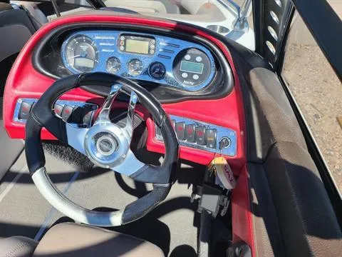 Slide: The Image of 2007 Malibu Response LXi boat dashboard with steering wheel and control panel. - 2