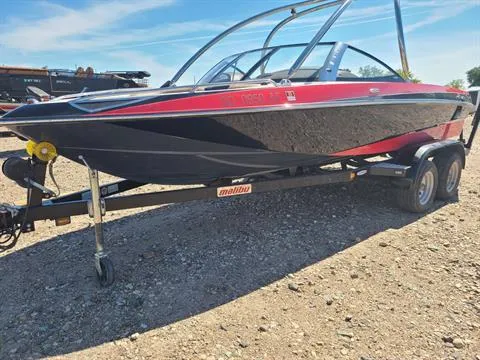 Slide: The Image of 2007 Malibu Response LXi boat on a trailer, red and black exterior, parked on gravel. - 3