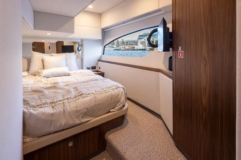 Slide: The Image of Luxurious bedroom interior of 2024 Riviera 46 Sports Motor Yacht with waterfront view. - 18