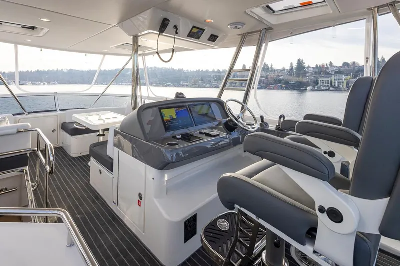 Slide: The Image of Interior of 2024 Riviera 46 Sports Motor Yacht with modern helm and seating. - 26