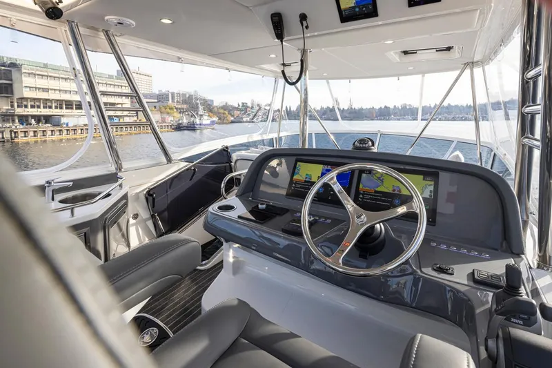 Slide: The Image of 2024 Riviera 46 Sports Motor Yacht helm with modern navigation systems. - 27