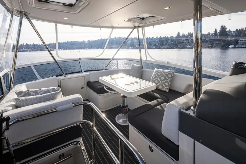 Slide: The Image of Luxurious interior of the 2024 Riviera 46 Sports Motor Yacht with scenic water view. - 28