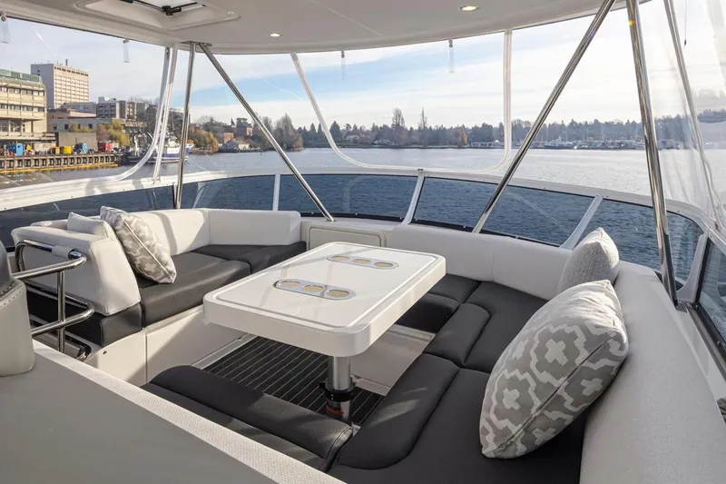 Slide: The Image of Luxurious seating area on the 2024 Riviera 46 Sports Motor Yacht with waterfront view. - 29