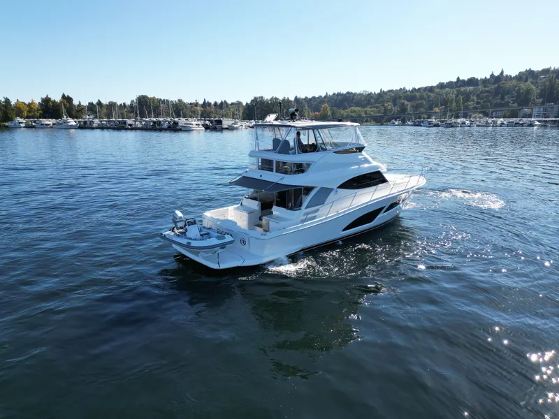 Slide: The Image of 2024 Riviera 46 Sports Motor Yacht cruising on a serene lake. - 3