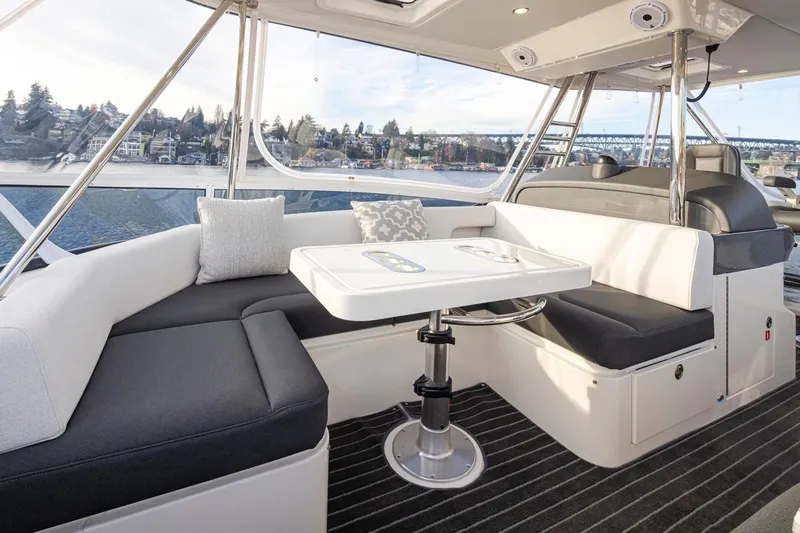 Slide: The Image of Interior seating area of 2024 Riviera 46 Sports Motor Yacht with scenic water view. - 30